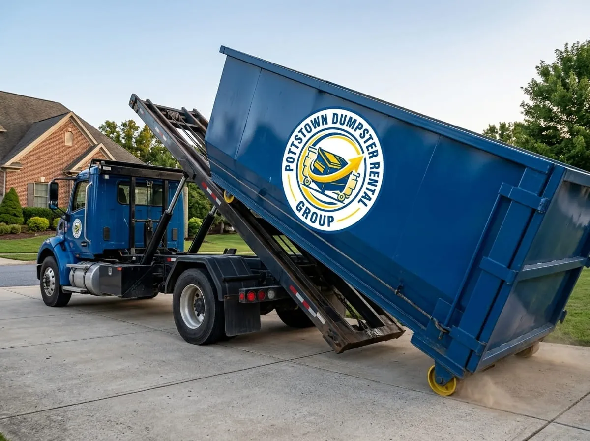 Roll-off construction dumpster being loaded onto a Pottstown Dumpster Rental Group truck